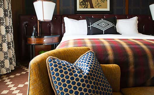 King bed and chair at Kimpton Riverplace